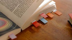 A book with many bookmark tabs attached.